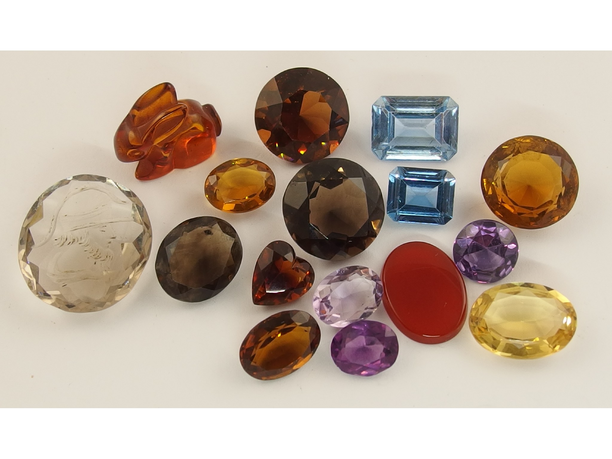 Appraisal: A collection of gemstones to include an amber coloured rabbit