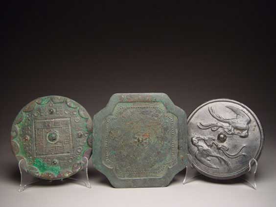 Appraisal: THREE ARCHAIC BRONZE MIRRORS Group of three Chinese archaic bronze