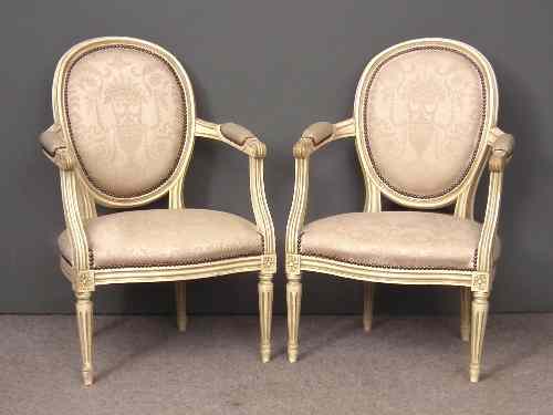 Appraisal: A pair of French cream finish beechwood oval backed fauteils