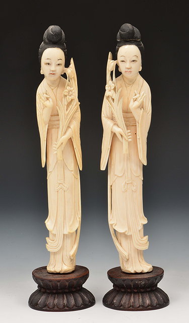 Appraisal: A pair of Chinese ivory models of Quanyin holding a