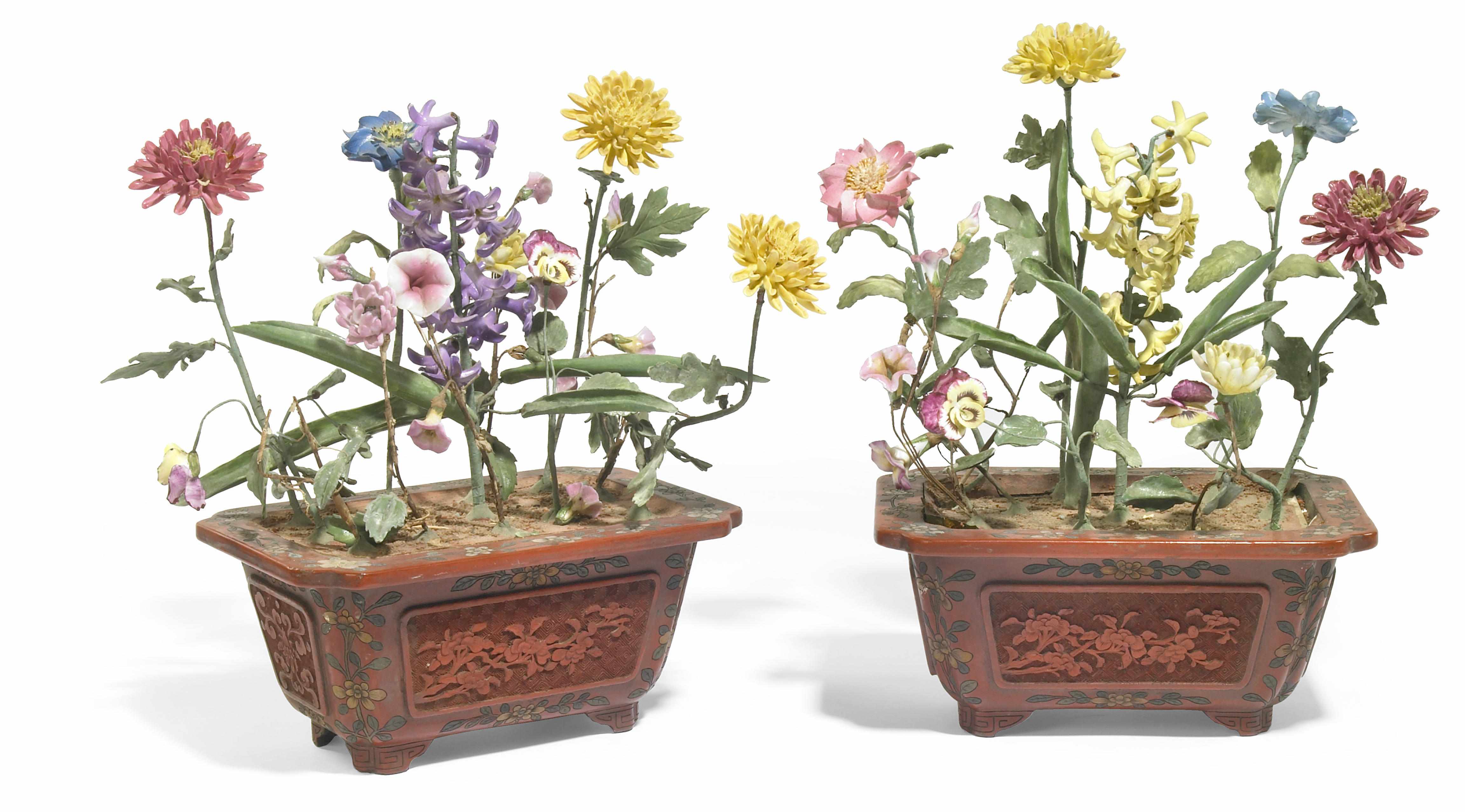 Appraisal: A pair of porcelain flowering plants in Chinese cinnabar lacquer