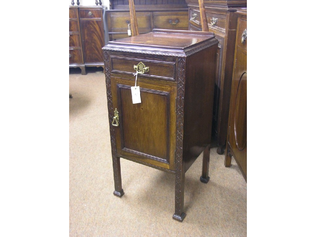 Appraisal: A George V mahogany bedside cupboard with blind-fret detail and