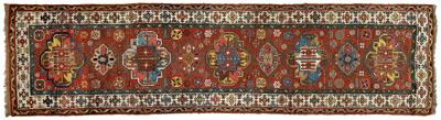 Appraisal: Caucasian runner nine central medallions on a brick red field