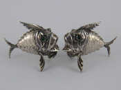 Appraisal: A pair of white metal tests silver articulated fish pepperettes