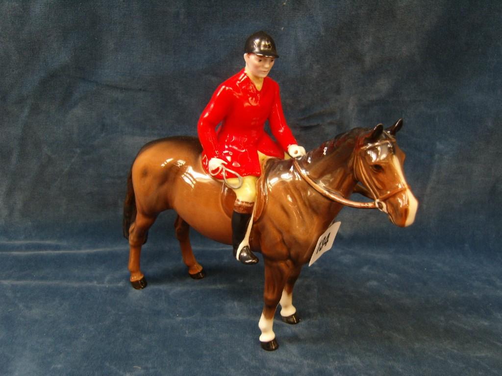 Appraisal: A Beswick model of a red jacketed huntsman seated on