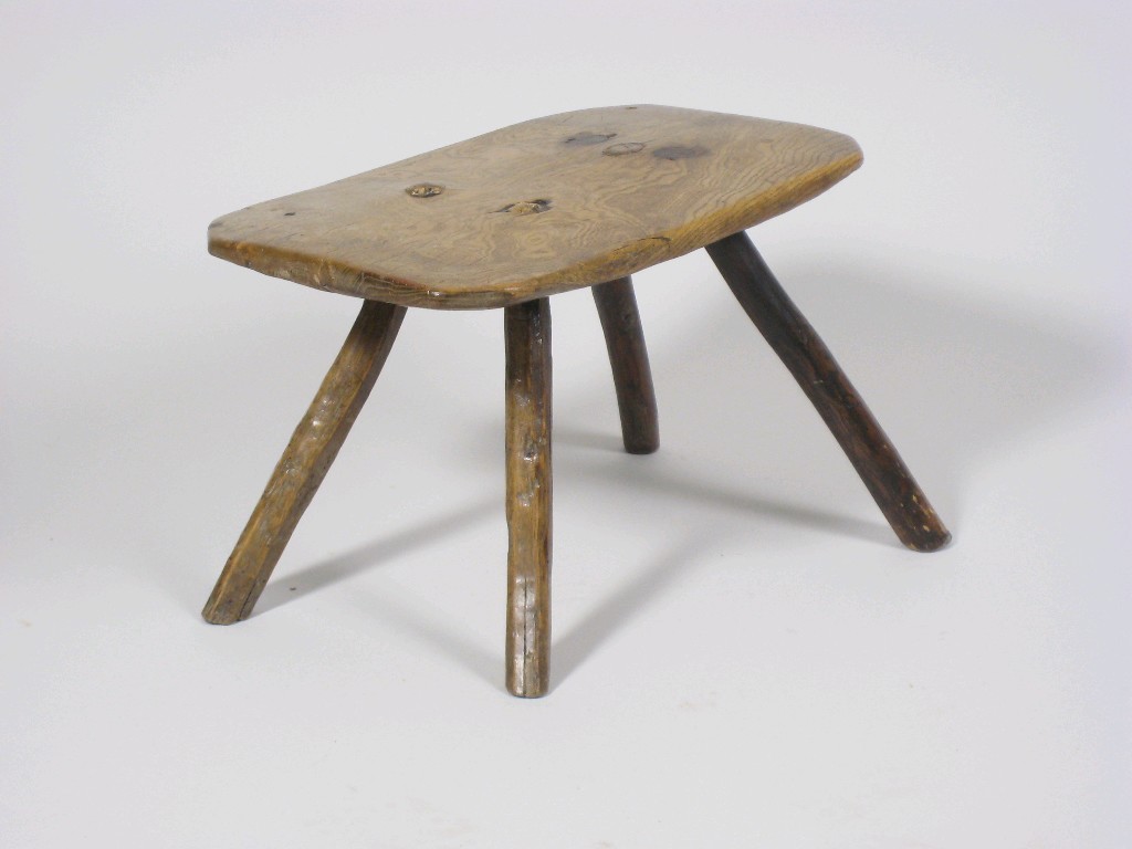 Appraisal: A Primitive Welsh oak Milking Stool on four splay stick