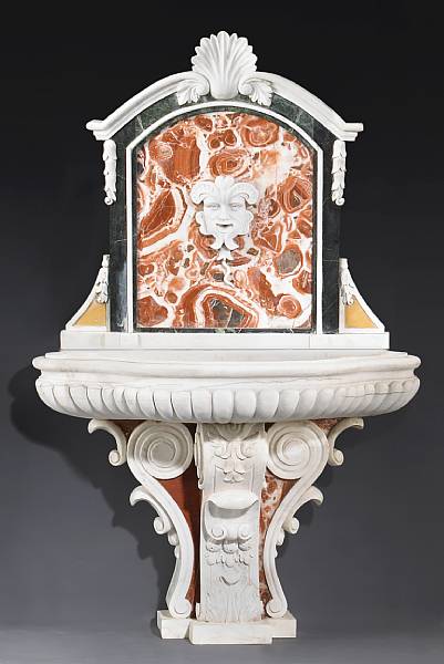 Appraisal: An Italian Baroque style white and variegated marble wall fountain