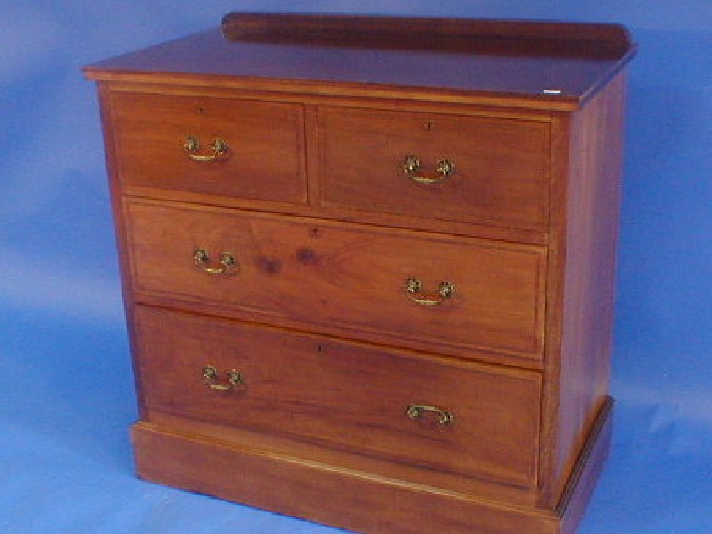 Appraisal: An Edwardian string inlaid mahogany chest of two short and