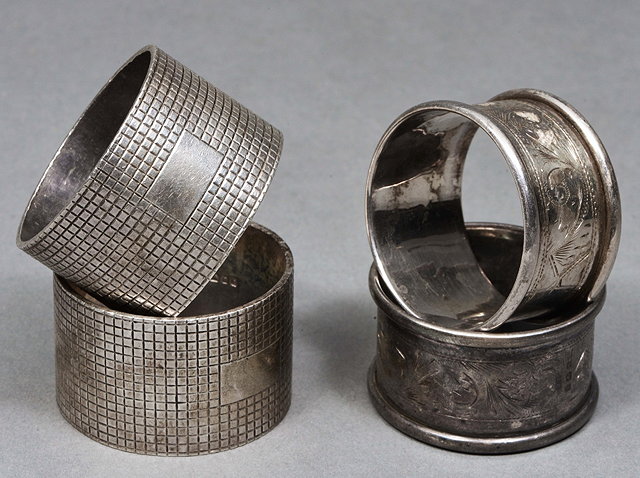 Appraisal: A PAIR OF SILVER NAPKIN RINGS with engraved chequered decoration