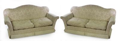 Appraisal: A pair of two-seater sofas upholstered in cream damask cm