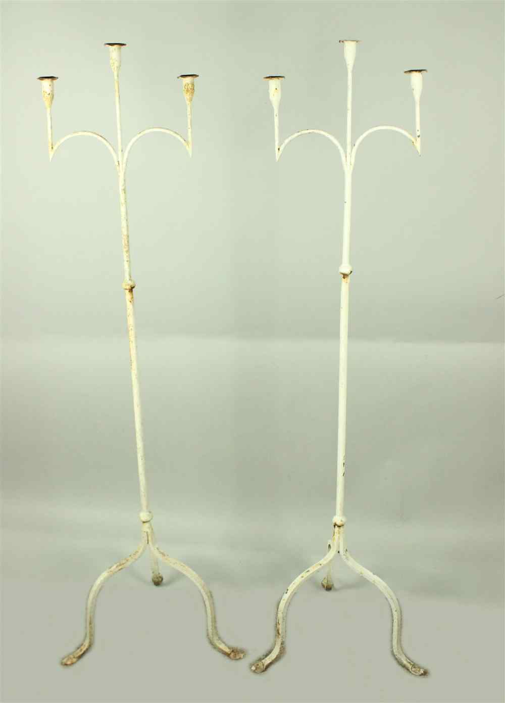 Appraisal: PAIR OF WHITE PAINTED METAL STANDING TORCHERES each with candlearms