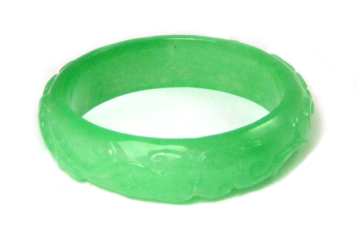 Appraisal: CARVED GREEN JADE BANGLE weighing grams and measuring inches in