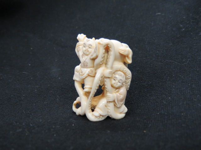 Appraisal: Carved Ivory Netsuke of Three Boysand an octopus signed excellent