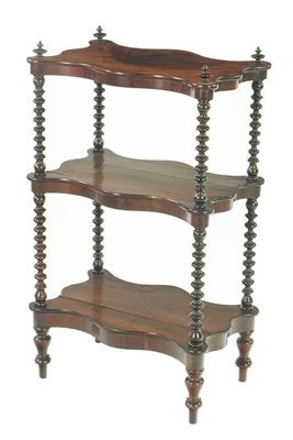 Appraisal: A th century rosewood serpentine edge three tier whatnot with