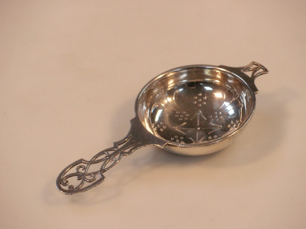 Appraisal: A George VI silver tea strainer with pierced handle Sheffield