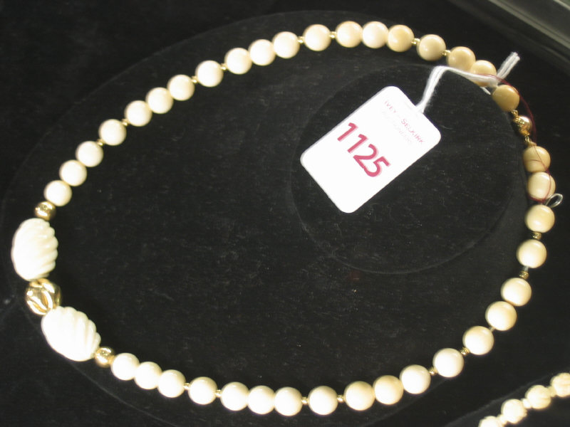 Appraisal: IVORY BEAD NECKLACE With k yellow gold polished beads and