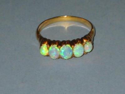 Appraisal: A FIVE STONE OPAL RING comprising graduated oval cabochons claw