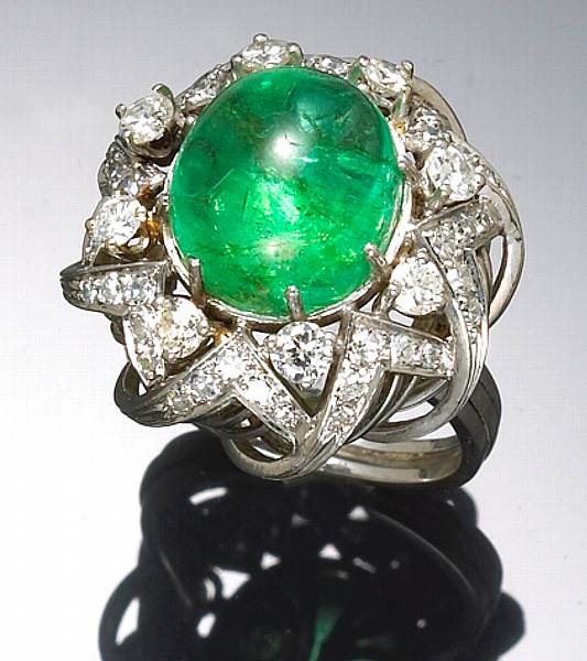 Appraisal: An emerald diamond and platinum ring centering an emerald cabochon