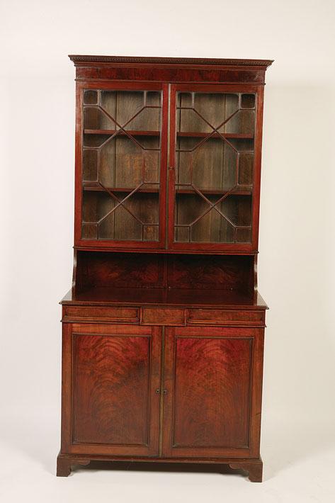 Appraisal: A REGENCY STYLE MAHOGANY BOOKCASE with astragal glazed doors to