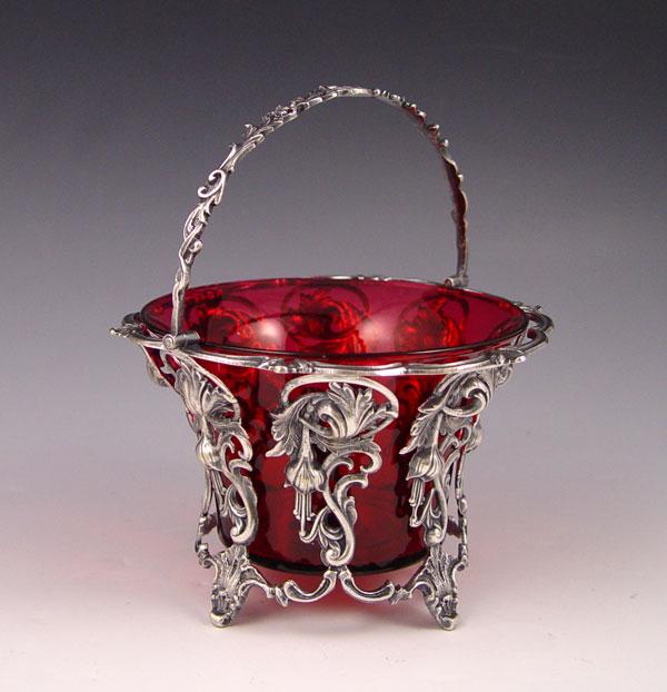 Appraisal: SILVERPLATE BASKET WITH CRANBERRY GLASS INSERT Articulated handle Unmarked as