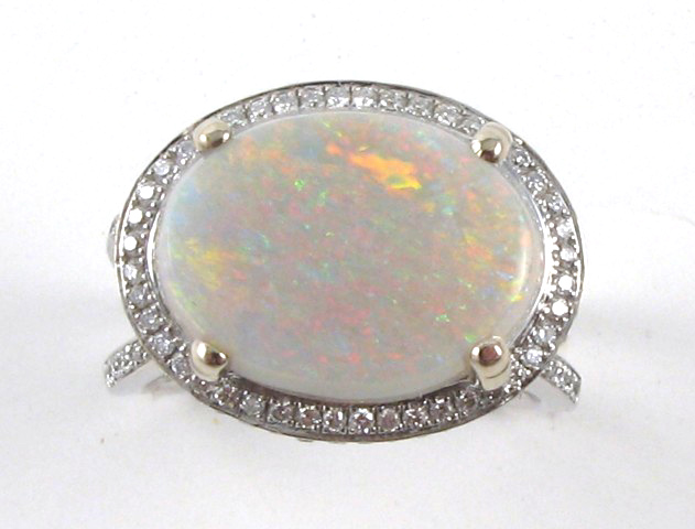 Appraisal: OPAL DIAMOND AND FOURTEEN KARAT GOLD RING centering an oval