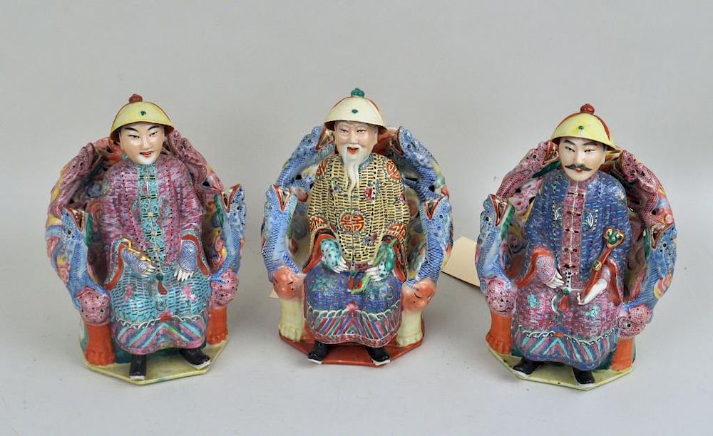 Appraisal: Group Three Chinese Enameled Court Figures on dragon form thrones