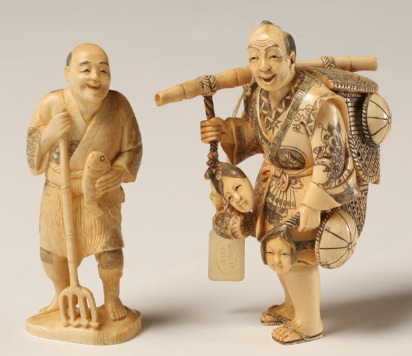 Appraisal: Japanese carved ivory netsuke a peddler and fisherman Tallest The