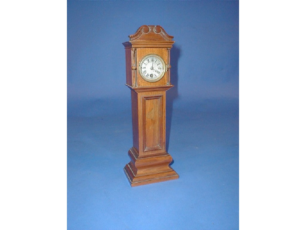 Appraisal: A miniature walnut long case timepiece with swan neck pediment