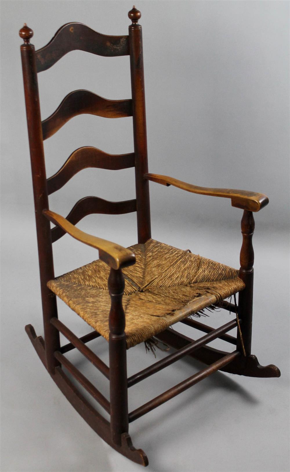 Appraisal: CHERRYWOOD AND MIXED WOODS LADDERBACK ROCKING CHAIR th C having