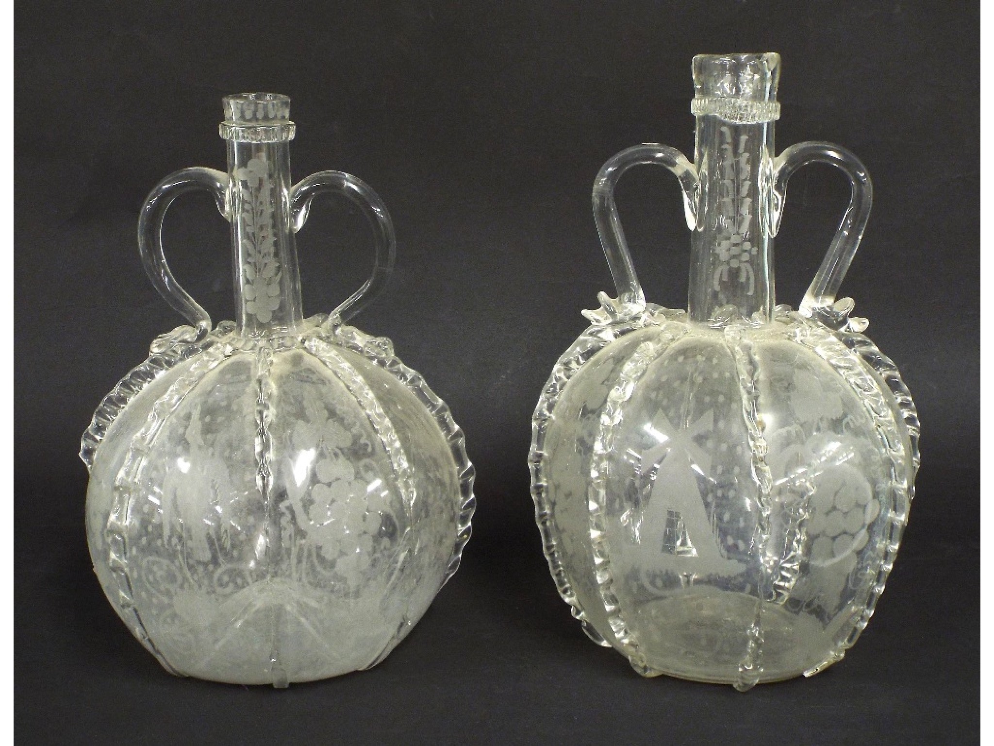 Appraisal: Matched pair of Continental antique glass twin handled globe decanters