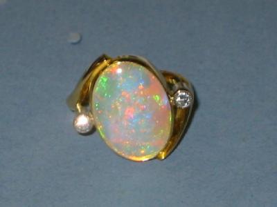 Appraisal: AN OPAL AND DIAMOND RING the polished oval opal collet