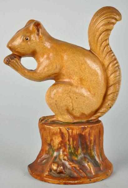 Appraisal: Cast Iron Squirrel with Nut on Stump Doorstop Condition Excellent