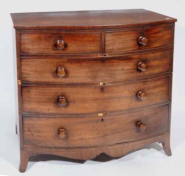 Appraisal: A GEORGIAN MAHOGANY BOW FRONTED CHEST of two short and