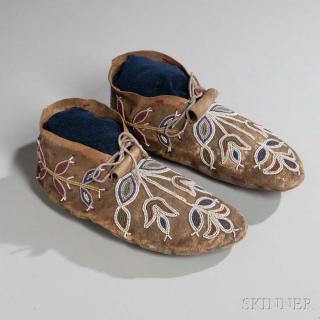 Appraisal: Blackfeet Beaded Buffalo Hide Moccasins c s the soft-sole forms