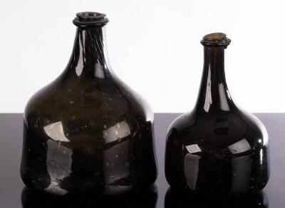 Appraisal: Two green glass onion wine bottles cm and cm high