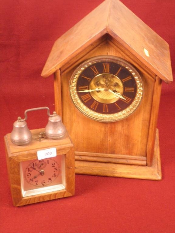 Appraisal: A pine cased mantel clock and an oak cased alarm