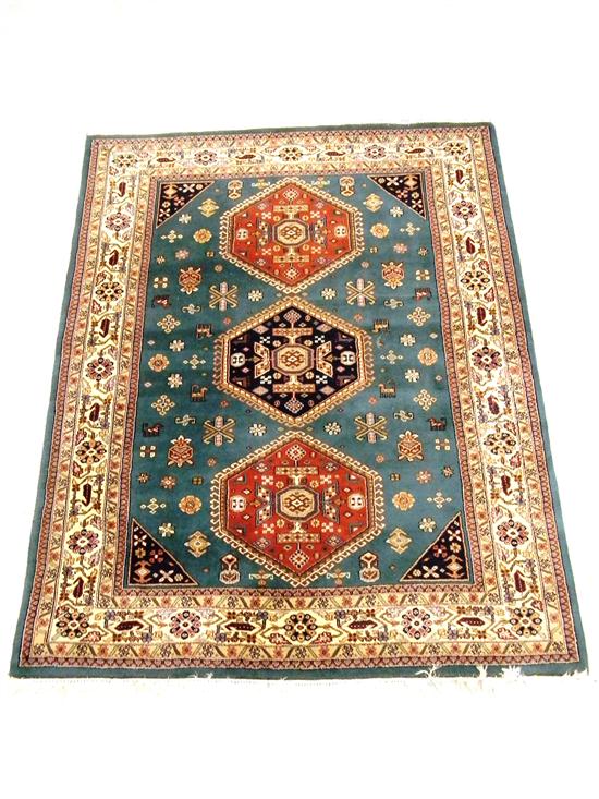 Appraisal: Indo-Caucasian rug teal field cream border rust colored and black