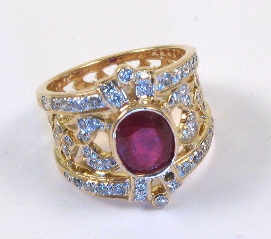 Appraisal: RUBY DIAMOND AND FOURTEEN KARAT GOLD RING centering an oval-cut