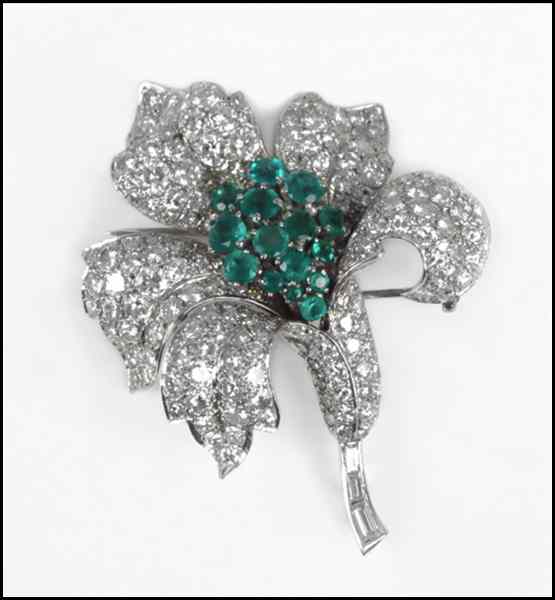 Appraisal: PLATINUM DIAMOND AND EMERALD FLOWER CLIP BROOCH round emeralds total