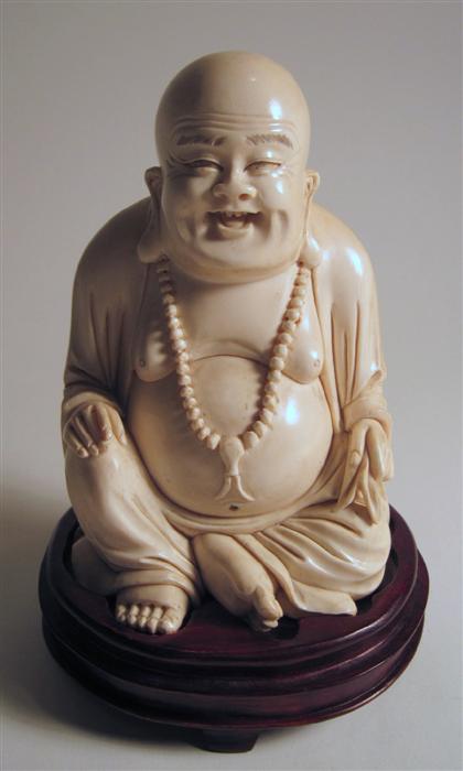 Appraisal: Chinese elephant ivory carving of Budai The typically-attired seated figure