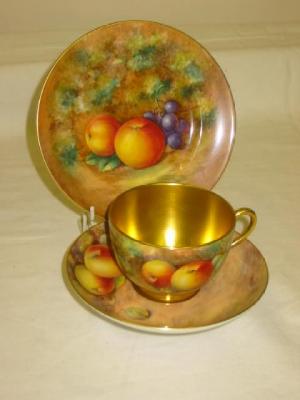 Appraisal: A ROYAL WORCESTER PORCELAIN TRIO painted with apples gooseberries and