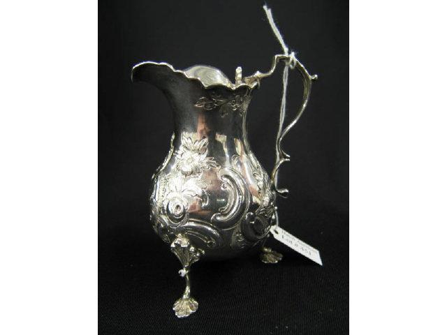 Appraisal: Georgian English Sterling Silver Cream Jug footed ornate design excellent