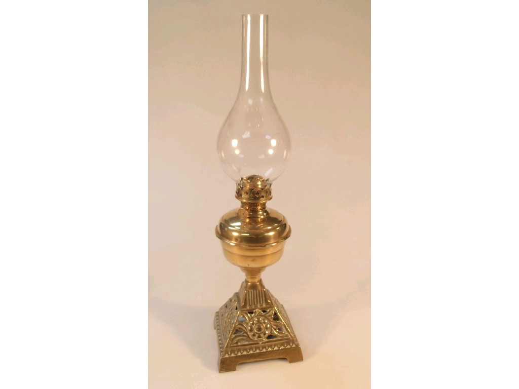 Appraisal: A thC brass oil lamp raised on a pierced pyramid