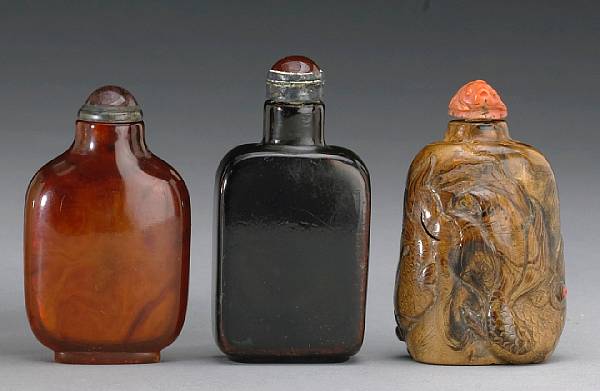 Appraisal: A group of three snuff bottles One of amber one