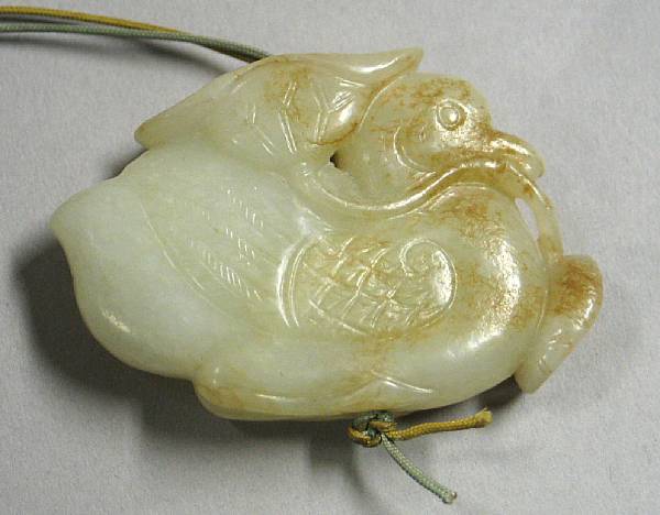 Appraisal: A nephrite toggle Of a mandarin duck holding a lotus