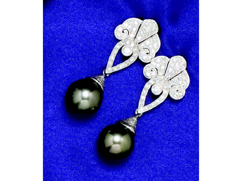 Appraisal: PLATINUM DIAMOND EARRINGS Set with two dangling black pearls mm