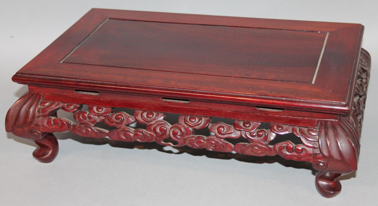 Appraisal: A Chinese hardwood low table the rectangular overhanging top raised