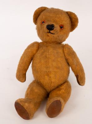 Appraisal: A teddy bear with glass eyes and swivel joints circa