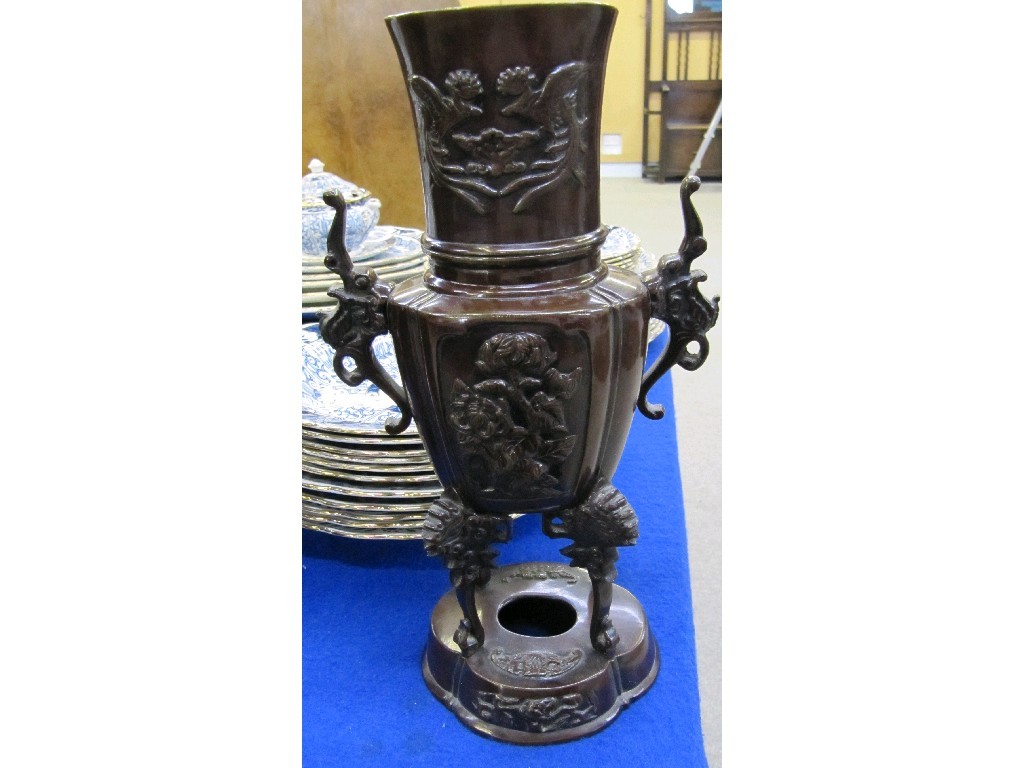 Appraisal: Oriental bronze vase decorated in relief sat upon four legs