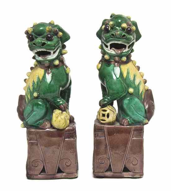 Appraisal: A Pair of Porcelain Fu Dogs with green yellow and